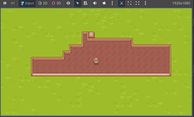 Godot game viewport showing a house with brick walls and a floor placed inside, with the character standing in it.